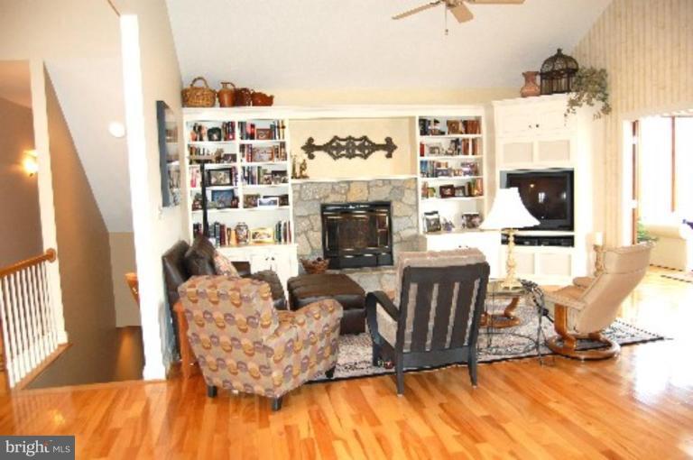 1133 Ragged Edge Road Chambersburg, PA 17202 - Photo 21 of 30 a living room with fireplace furniture and a flat screen tv