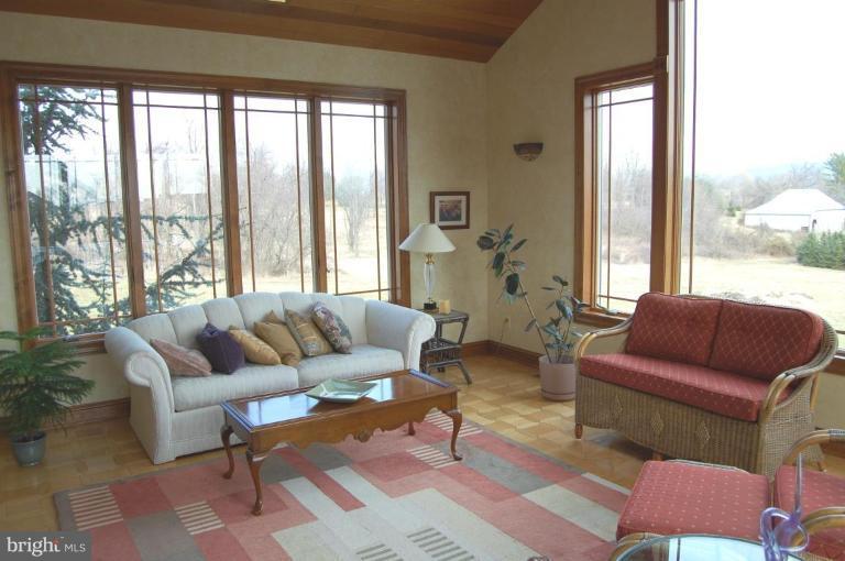 1133 Ragged Edge Road Chambersburg, PA 17202 - Photo 22 of 30 a living room with furniture and a large window
