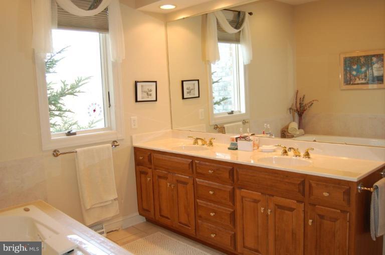 1133 Ragged Edge Road Chambersburg, PA 17202 - Photo 26 of 30 a bathroom with a double vanity sink and a mirror