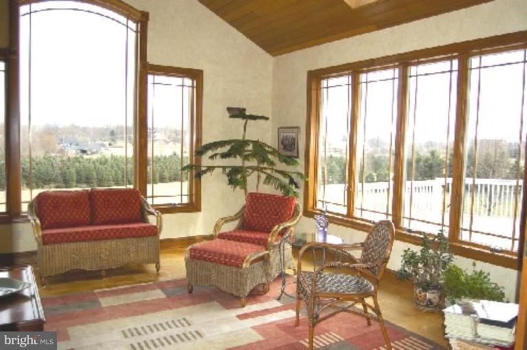 1133 Ragged Edge Road Chambersburg, PA 17202 - Photo 8 of 30 a living room with furniture and a floor to ceiling window