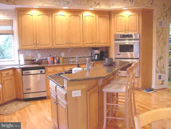 1133 Ragged Edge Road Chambersburg, PA 17202 - Photo 10 of 30 a kitchen with stainless steel appliances a stove a sink and a microwave