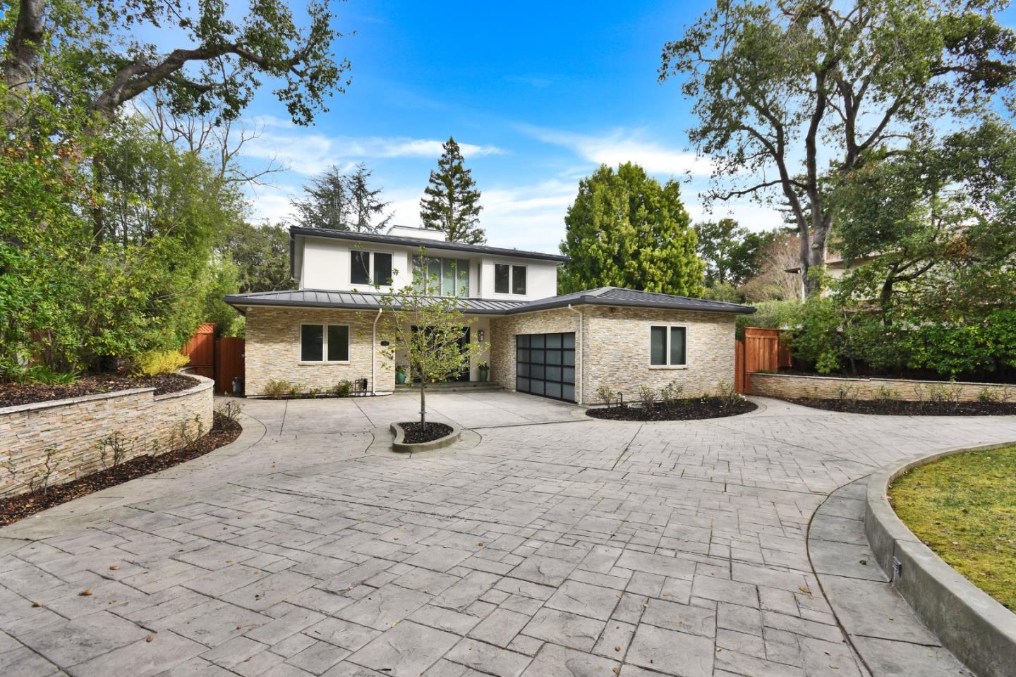 a front view of a house with a yard and a garage