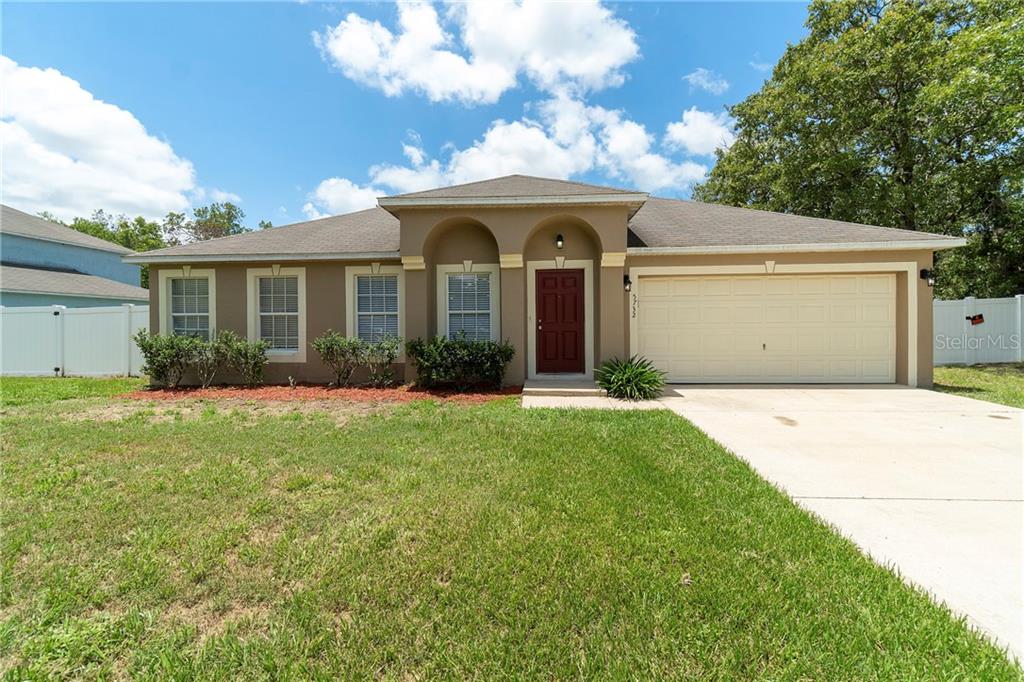 5732 Southwest 116th Pl Road Ocala, FL 34476 - Photo 1 of 1 a front view of a house with garden