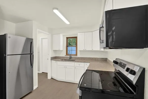 a kitchen with a refrigerator and a sink
