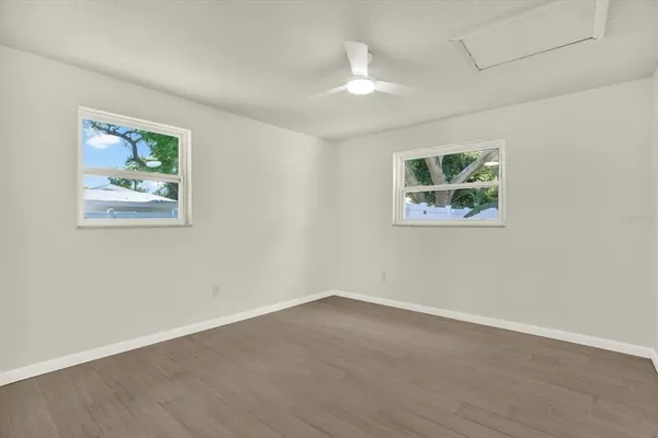 a view of an empty room with a painting on the wall