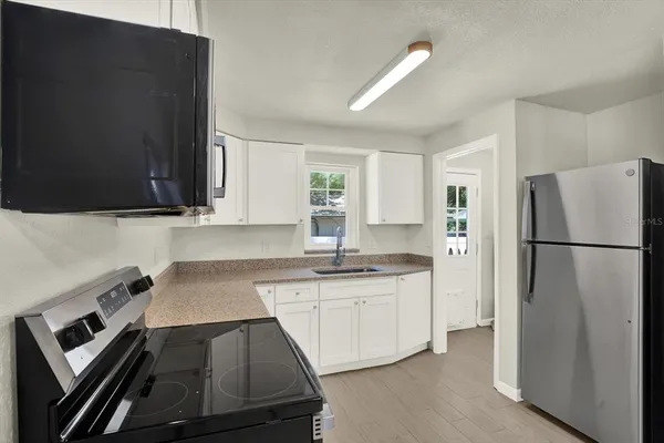 a kitchen with a sink stove and refrigerator