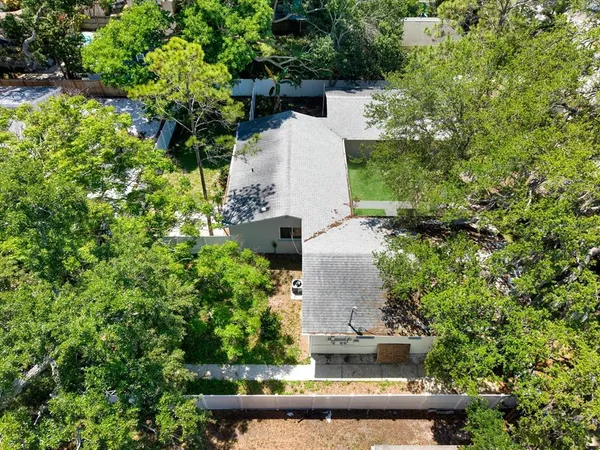 an aerial view of a house with a yard