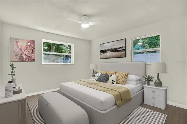 a bedroom with a bed and a painting on the wall