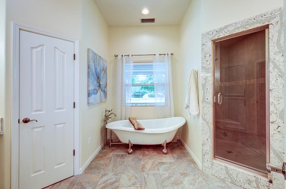 17465 Monreal Road Madera, CA 93636 - Photo 35 of 59 a spacious bathroom with a bathtub and shower