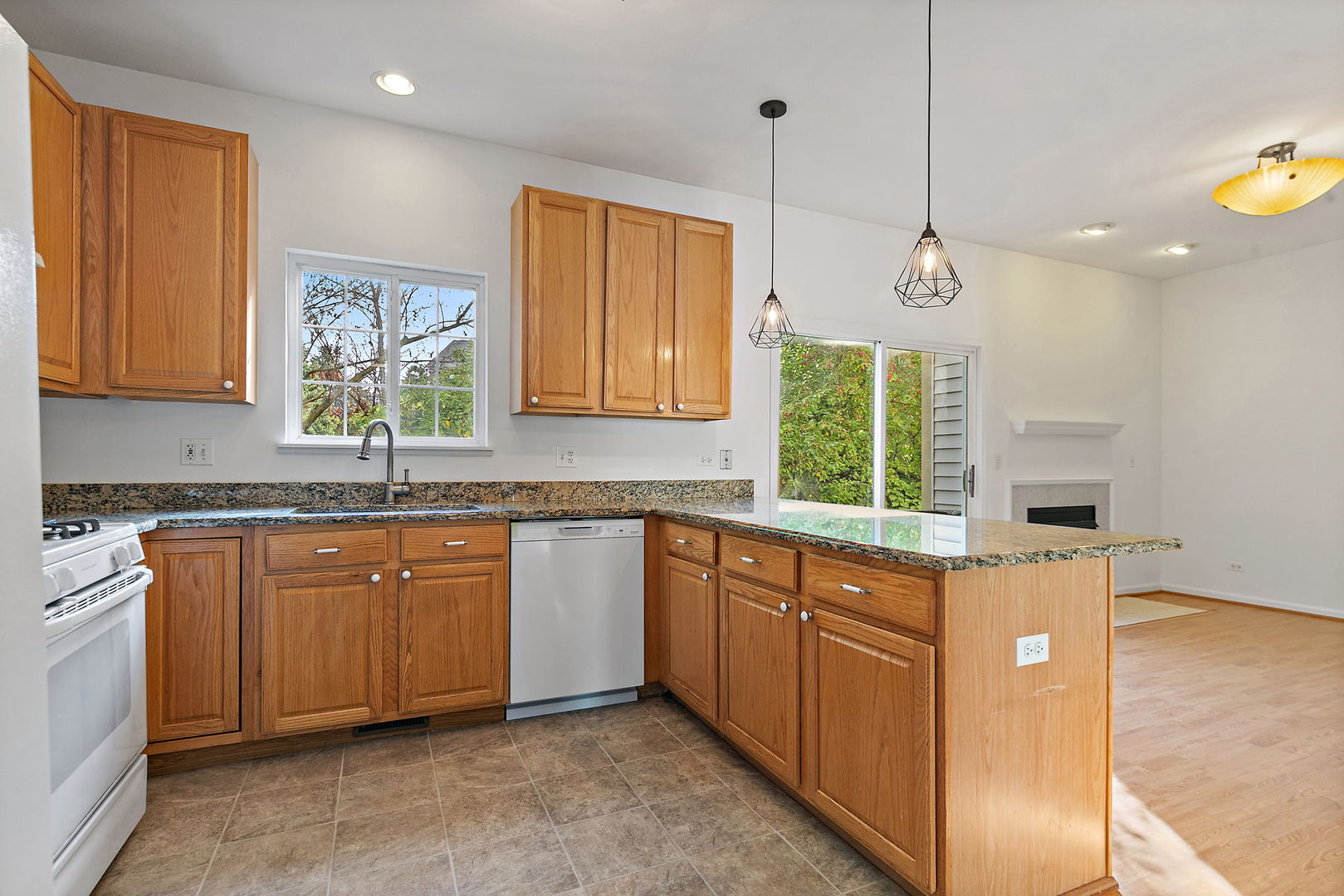 71 Monarch Drive Streamwood, IL 60107 - Photo 3 of 19 a kitchen with stainless steel appliances granite countertop wooden cabinets a window and a sink