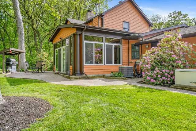 a living room with furniture a flat screen tv and large windows