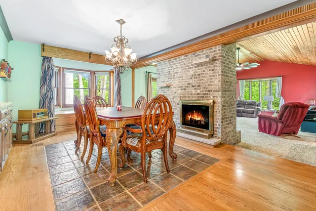 a kitchen with stainless steel appliances granite countertop a sink a stove cabinets counter space and a large window