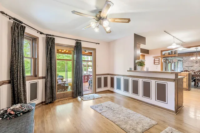 a spacious bedroom with a bed and a chandelier
