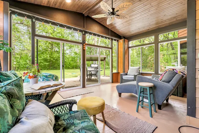 a bedroom with a bed and a large mirror on the dresser