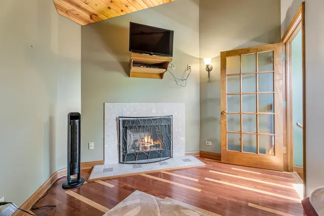 a view of empty room with fireplace and window