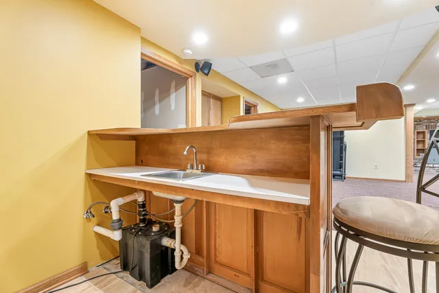 a front view of a house with a yard and trees