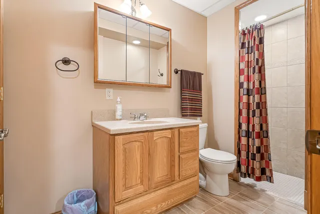 a view of a house with a big yard and large trees