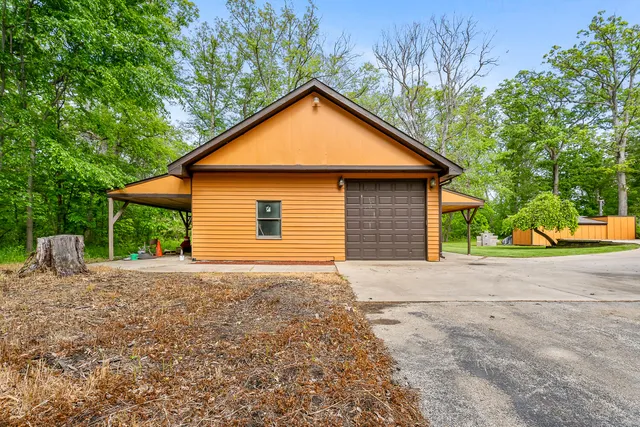 an aerial view of residential house with outdoor space and swimming pool