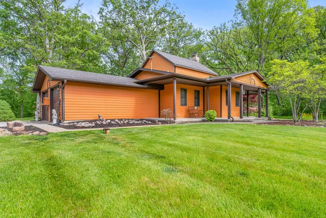 a front view of a house with a yard table and chairs