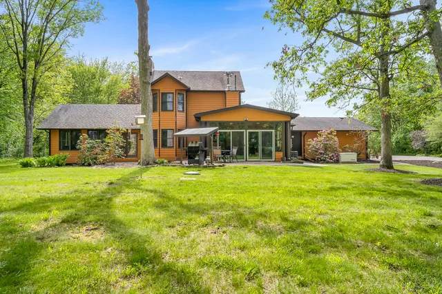 a view of a dining room with furniture a chandelier and wooden floor