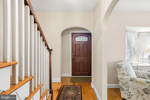 a view of hallway with wooden floor and stairs