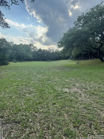 a view of a patio with table and chairs potted plants