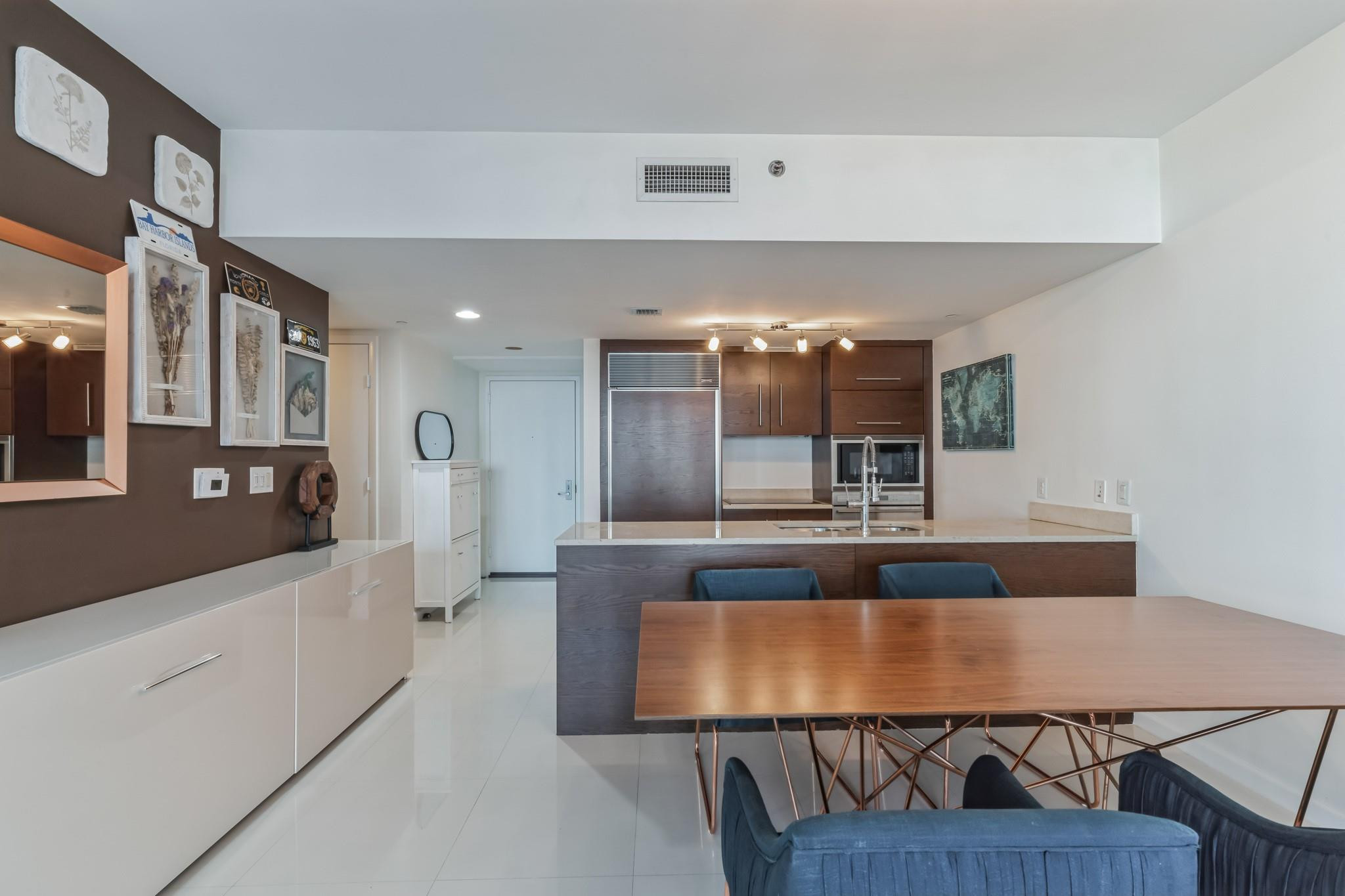 475 Brickell Avenue, Unit 512 Miami, FL 33131 - Photo 18 of 36 a view of living room with kitchen island stainless steel appliances wooden floor and living room view