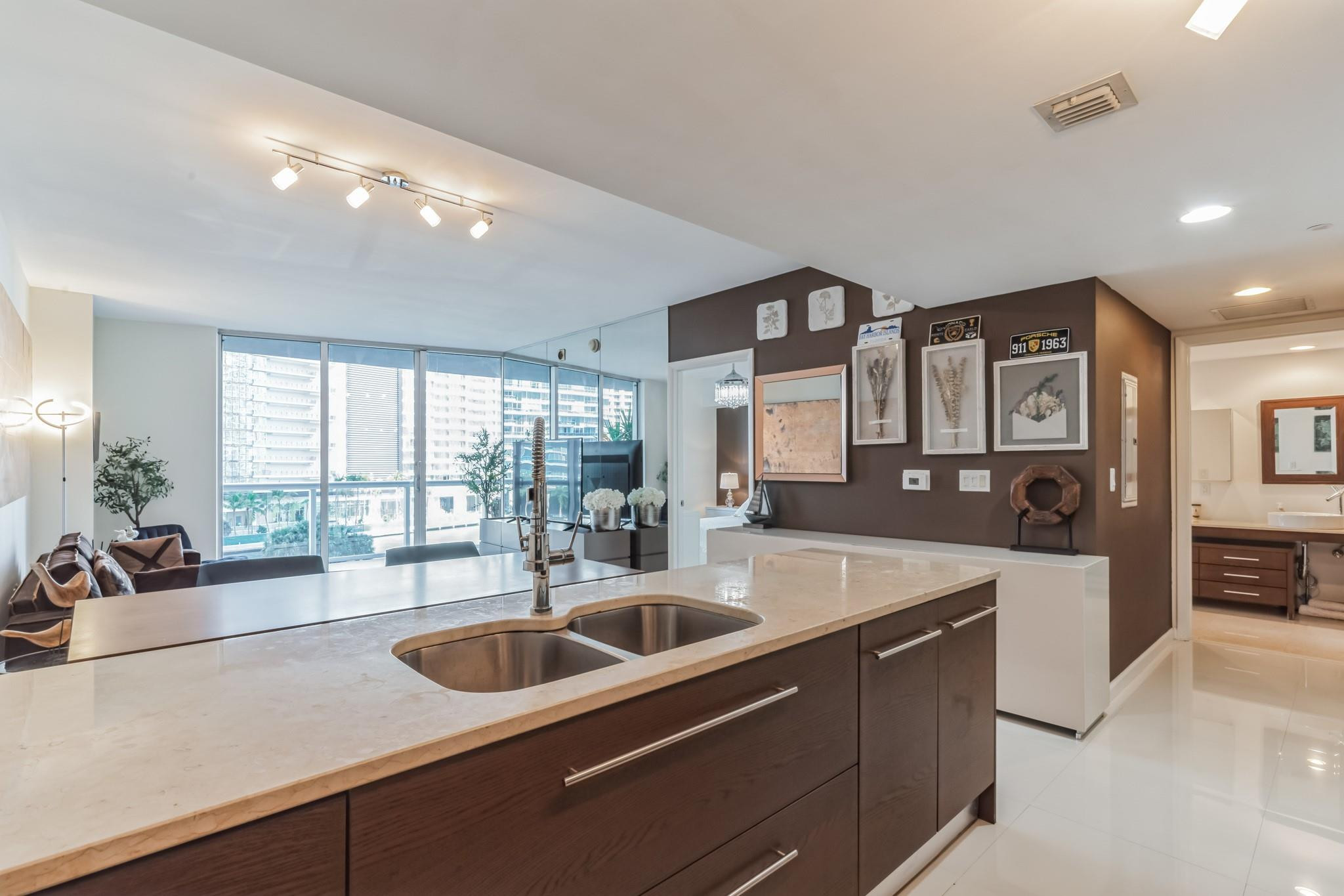 475 Brickell Avenue, Unit 512 Miami, FL 33131 - Photo 20 of 36 a kitchen with stainless steel appliances granite countertop a sink and a large window