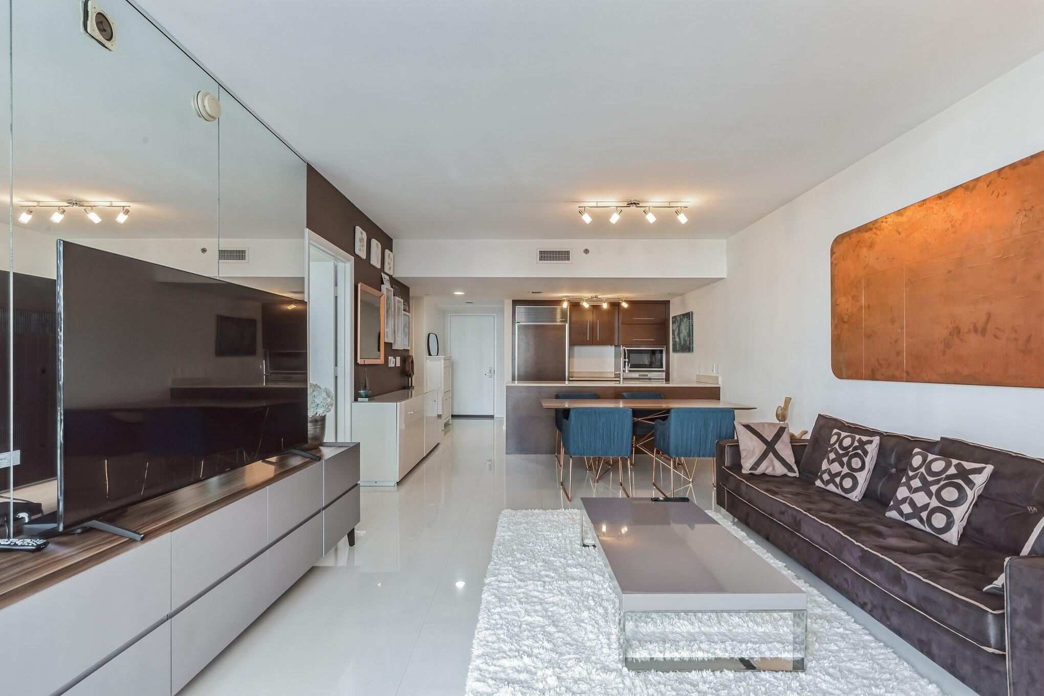 475 Brickell Avenue, Unit 512 Miami, FL 33131 - Photo 8 of 36 a living room with furniture and a flat screen tv