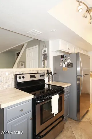 a kitchen with granite countertop a stove and a refrigerator