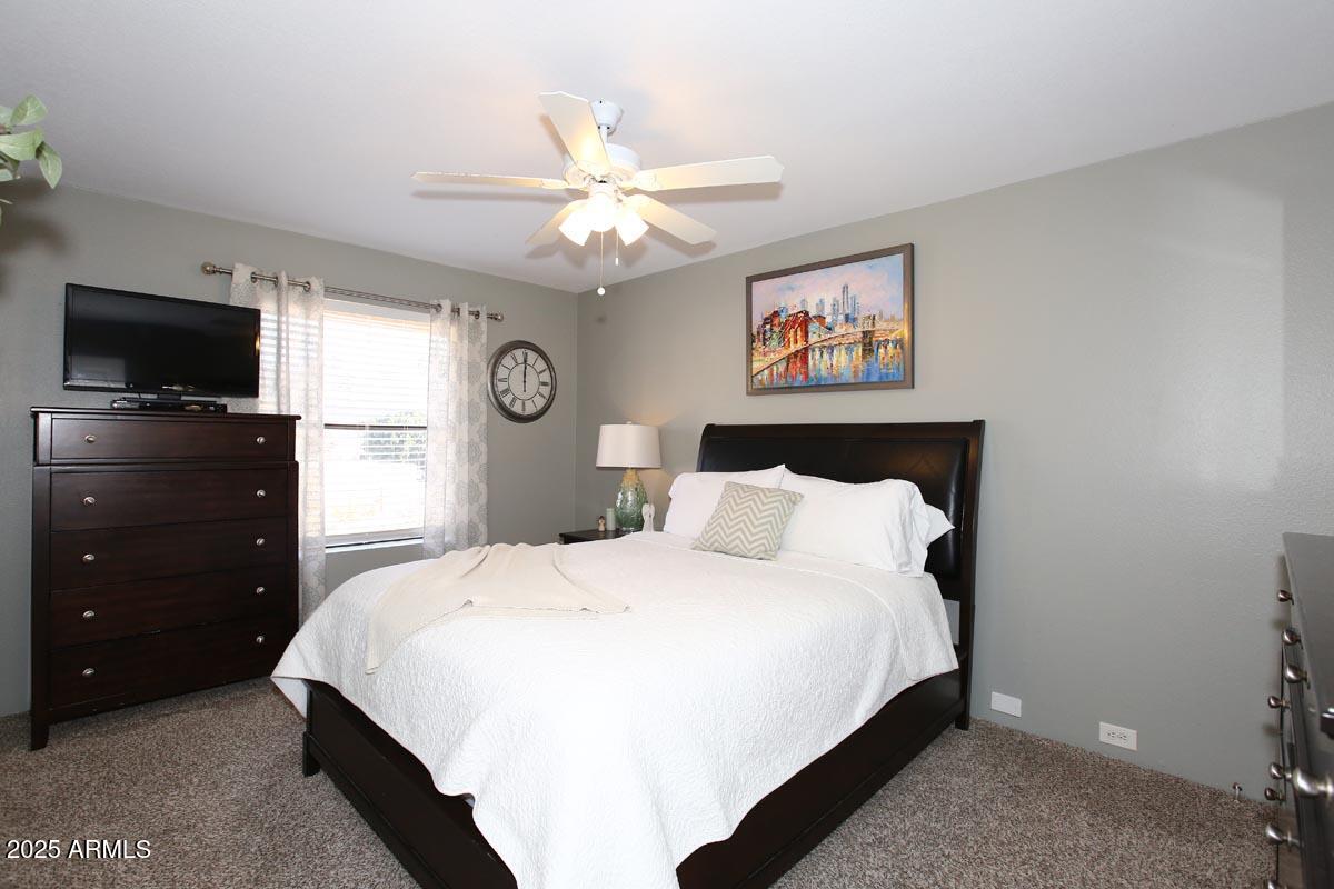 10408 North 11th Place, Unit 3 Phoenix, AZ 85020 - Photo 16 of 31 a bedroom with a bed and a flat screen tv