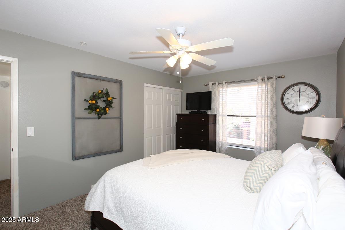 10408 North 11th Place, Unit 3 Phoenix, AZ 85020 - Photo 17 of 31 a bedroom with a large bed and a chandelier