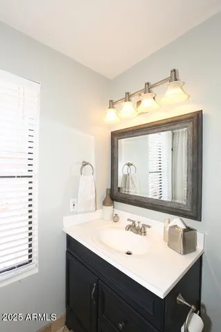 a bathroom with a sink and a mirror