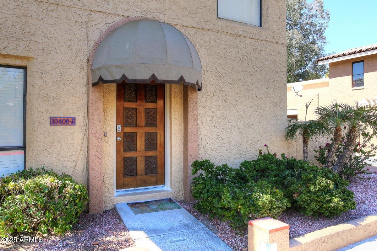 10408 North 11th Place, Unit 3 Phoenix, AZ 85020 - Photo 2 of 31 a front view of a house with a yard