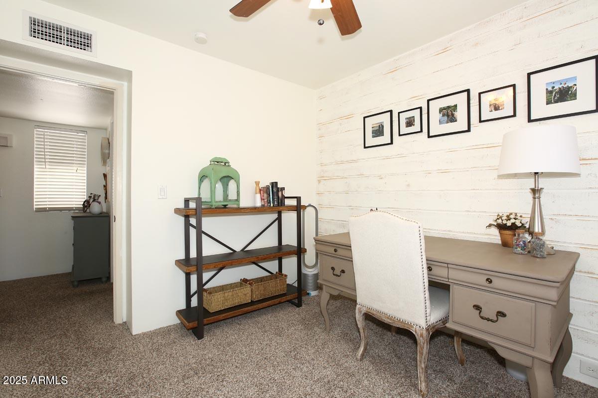 10408 North 11th Place, Unit 3 Phoenix, AZ 85020 - Photo 21 of 31 a bedroom with a bed and a chandelier