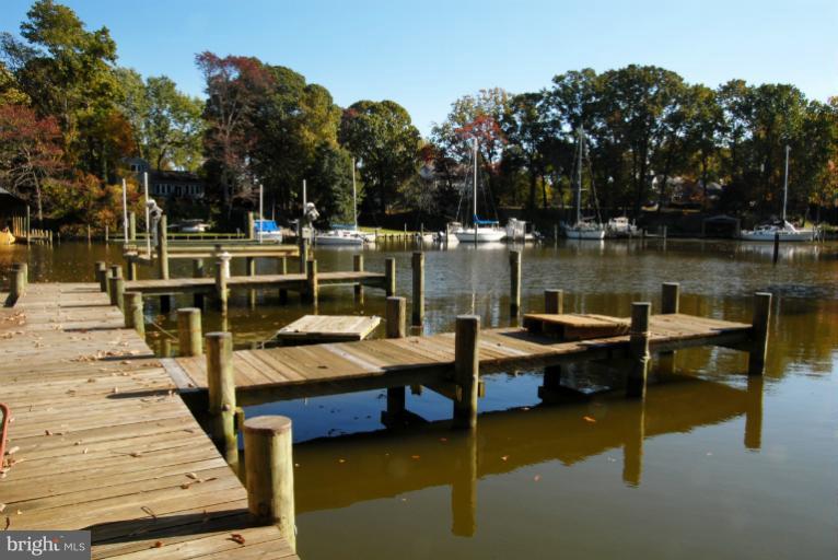 1821 Hidden Point Road Annapolis, MD 21409 - Photo 16 of 30 a view of a lake with couches wooden fence and floor
