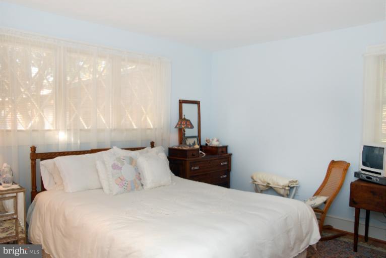 1821 Hidden Point Road Annapolis, MD 21409 - Photo 17 of 30 a bedroom with a bed and a chair