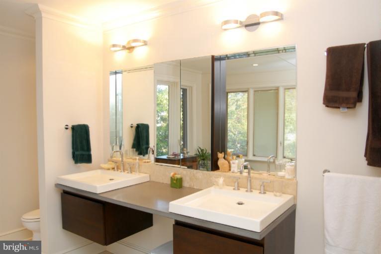 1821 Hidden Point Road Annapolis, MD 21409 - Photo 22 of 30 a bathroom with a sink and a mirror