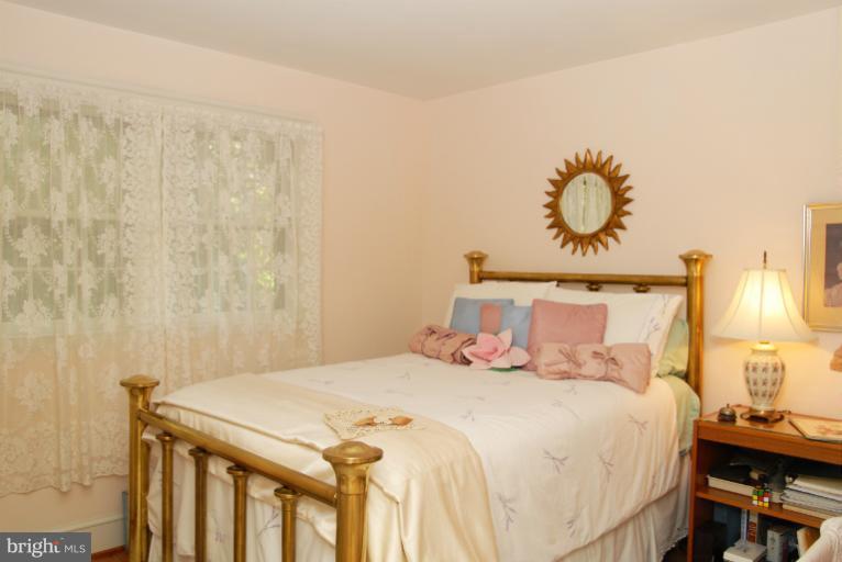 1821 Hidden Point Road Annapolis, MD 21409 - Photo 10 of 30 a bedroom with a bed and a chandelier
