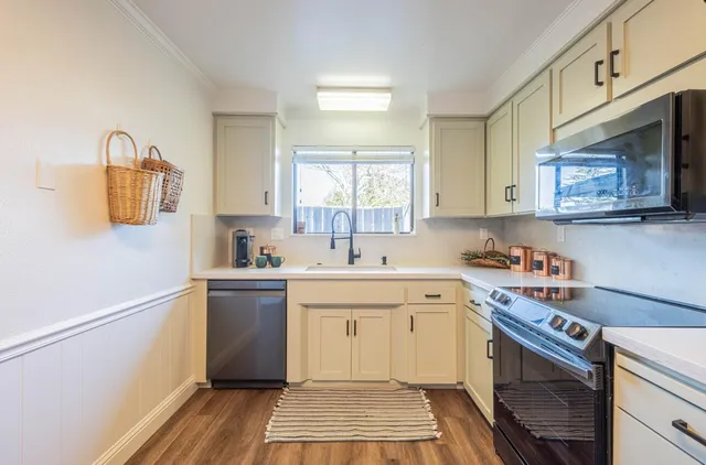 a kitchen with a sink cabinets and window