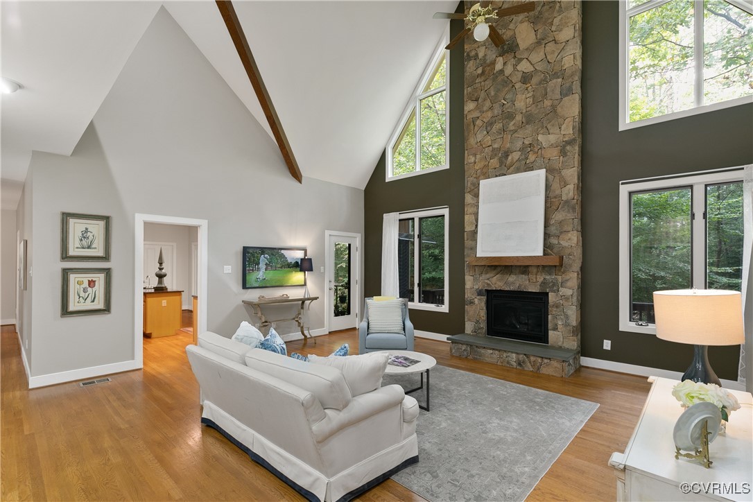 12293 Stancroft Road Rockville, VA 23146 - Photo 15 of 49 Living room featuring a stone fireplace, ceiling f