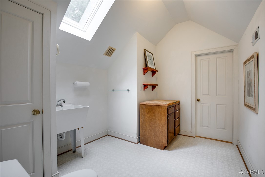 12293 Stancroft Road Rockville, VA 23146 - Photo 33 of 49 Bathroom with lofted ceiling with skylight and sin