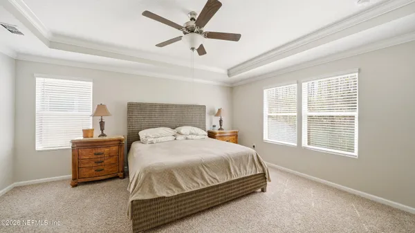 a bedroom with a bed dresser and a window