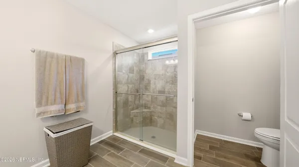 a bathroom with a shower and a toilet