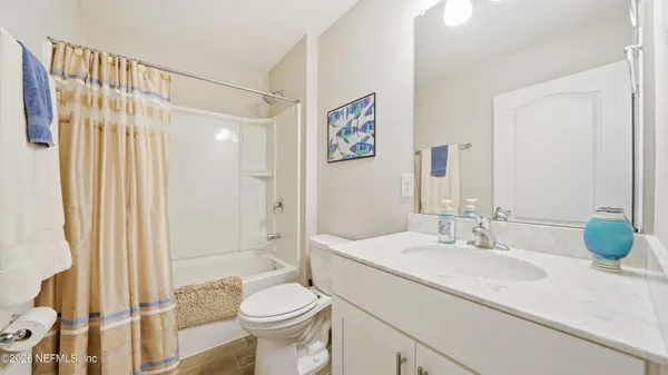 a view of a kitchen with refrigerator and wooden floor