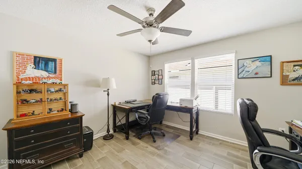 a view of a workspace with furniture and a window
