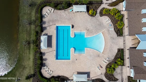 an aerial view of a house with a swimming pool