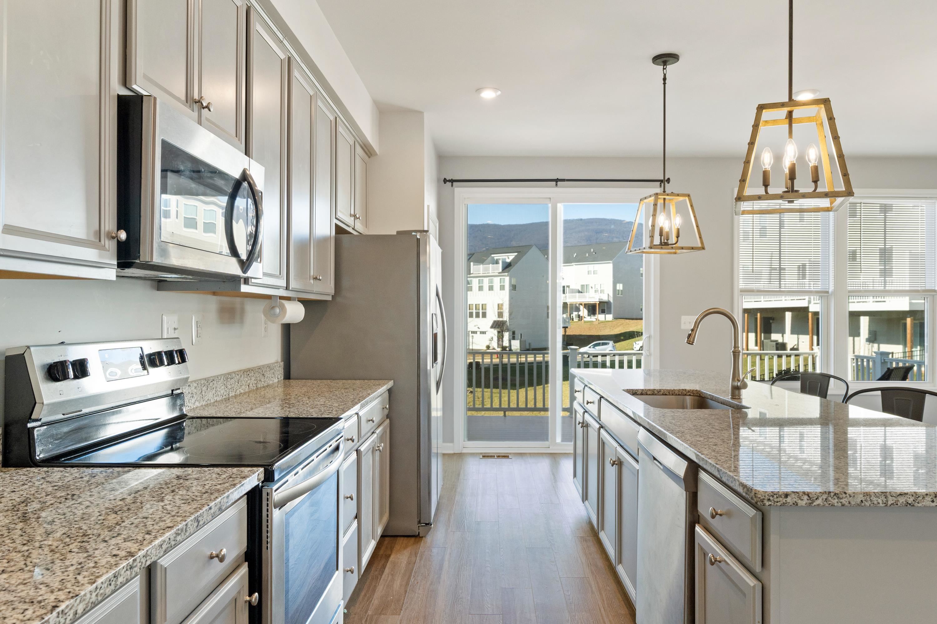 4416 Alston Street Crozet, VA 22932 - Photo 11 of 36 a kitchen with stainless steel appliances granite countertop a sink a stove and a wooden floors
