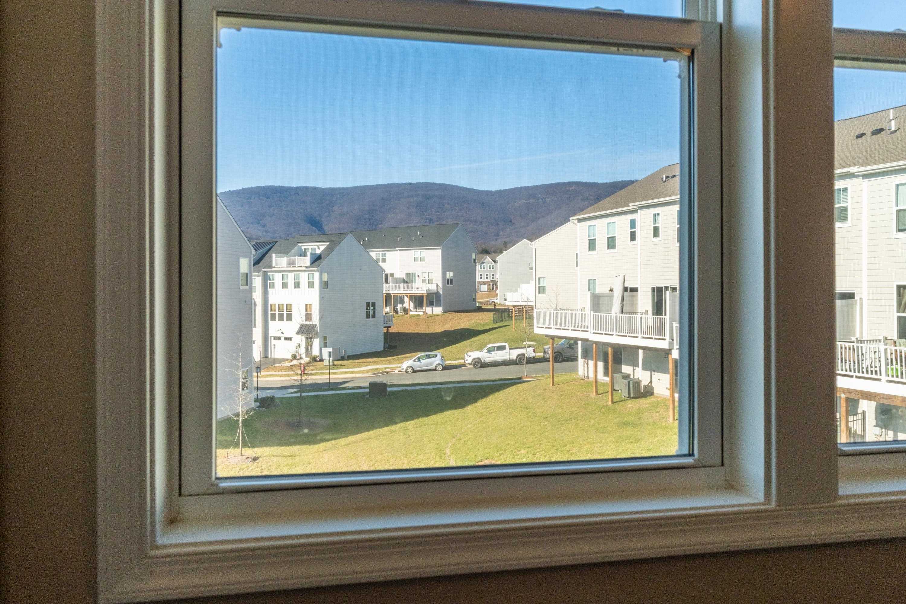 4416 Alston Street Crozet, VA 22932 - Photo 20 of 36 a view of a living room with a floor to ceiling window and a table