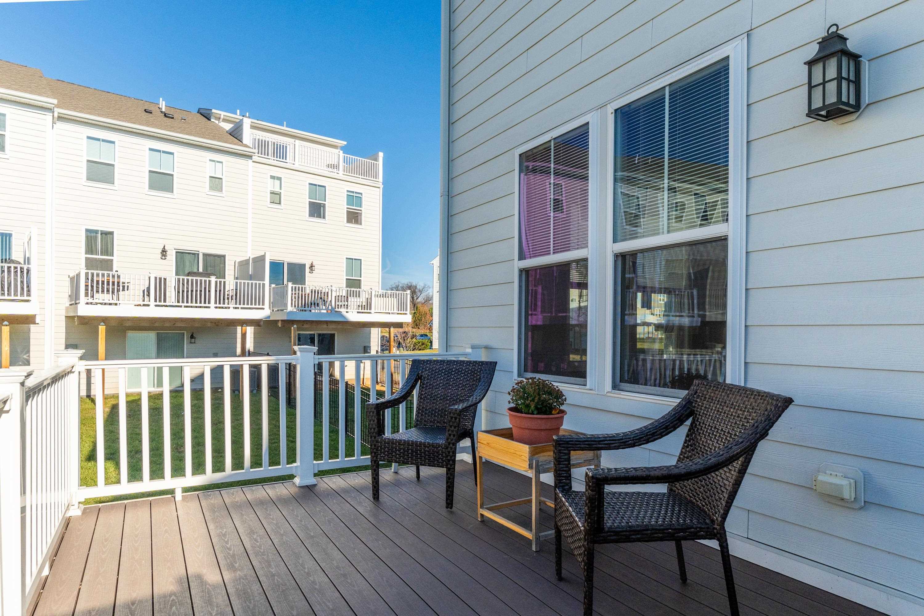 4416 Alston Street Crozet, VA 22932 - Photo 31 of 36 a view of a building from a chairs and table in the balcony